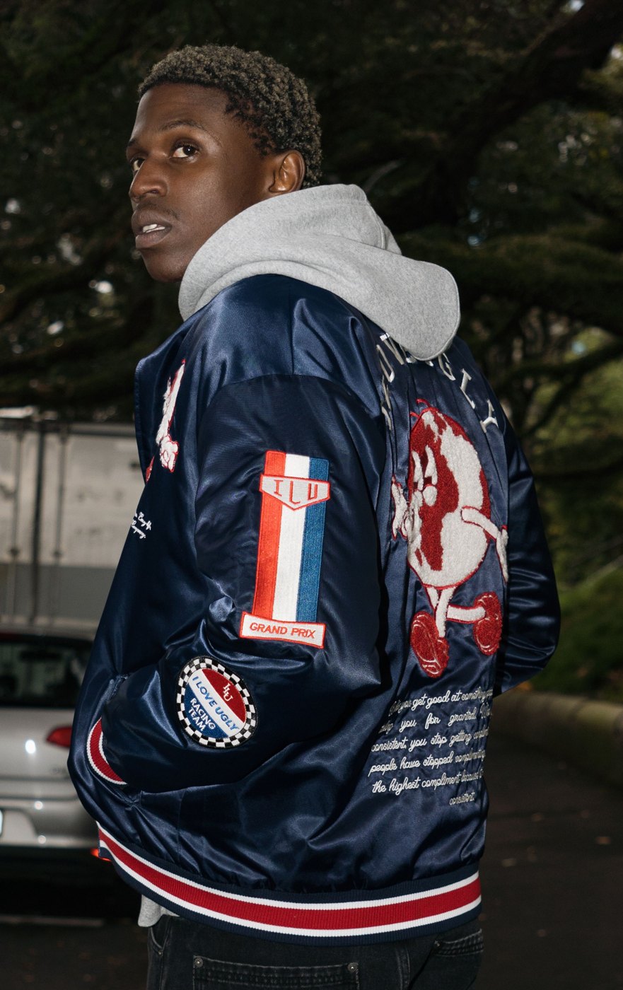 Back and sleeve of the World Wide Bomber with racing patches and embroidered back graphic