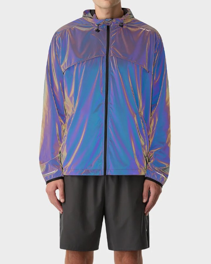 Reflective windbreaker lit up in iridescent purple and blue under flash