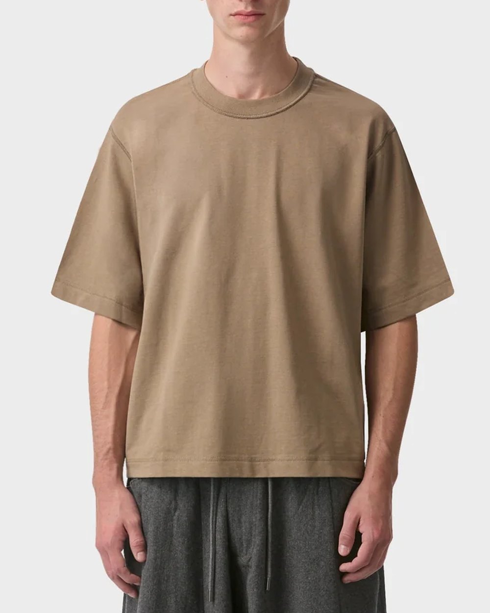 Tan cropped boxy tee worn with grey wool pants