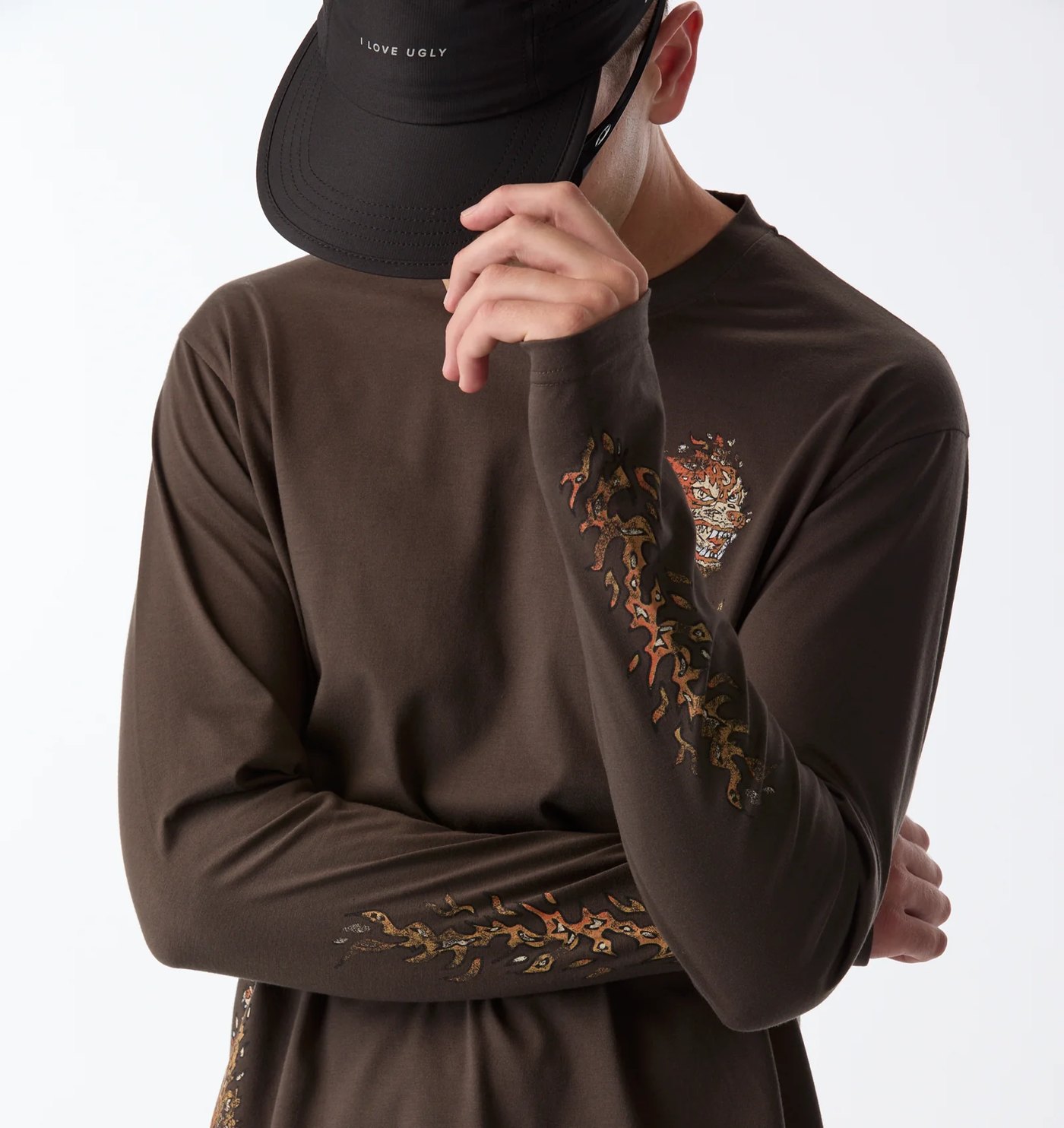 Brown long sleeve tee with fire bird graphics on the chest and sleeves