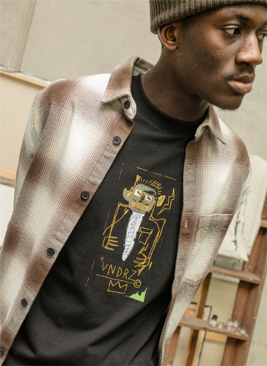 I Love Ugly x Jean-Michel Basquiat: Black VNDRZ artwork tee under the ombré check overshirt