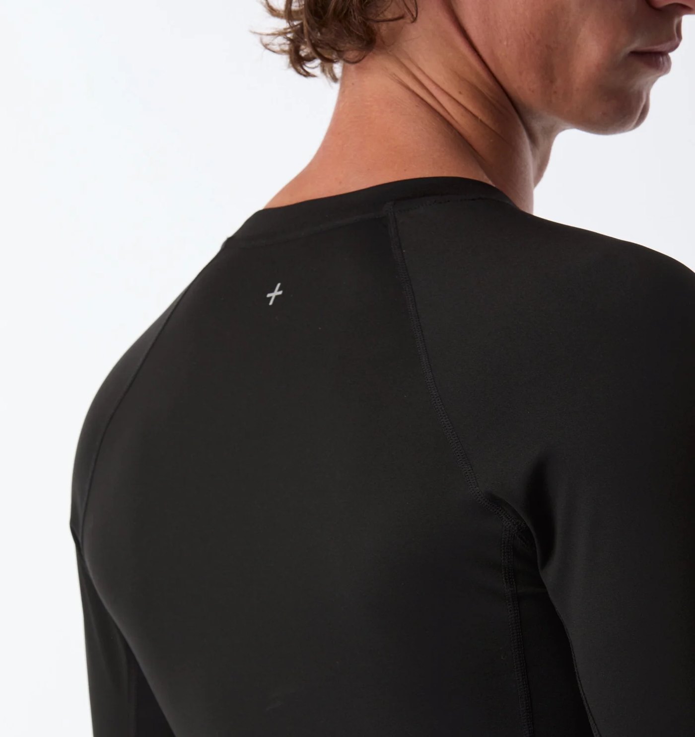 Close-up of the raglan seams and reflective cross mark on the back