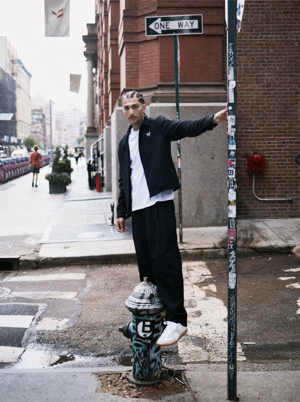 I Love Ugly x Keith Haring: Black zip jacket and pants on a street corner