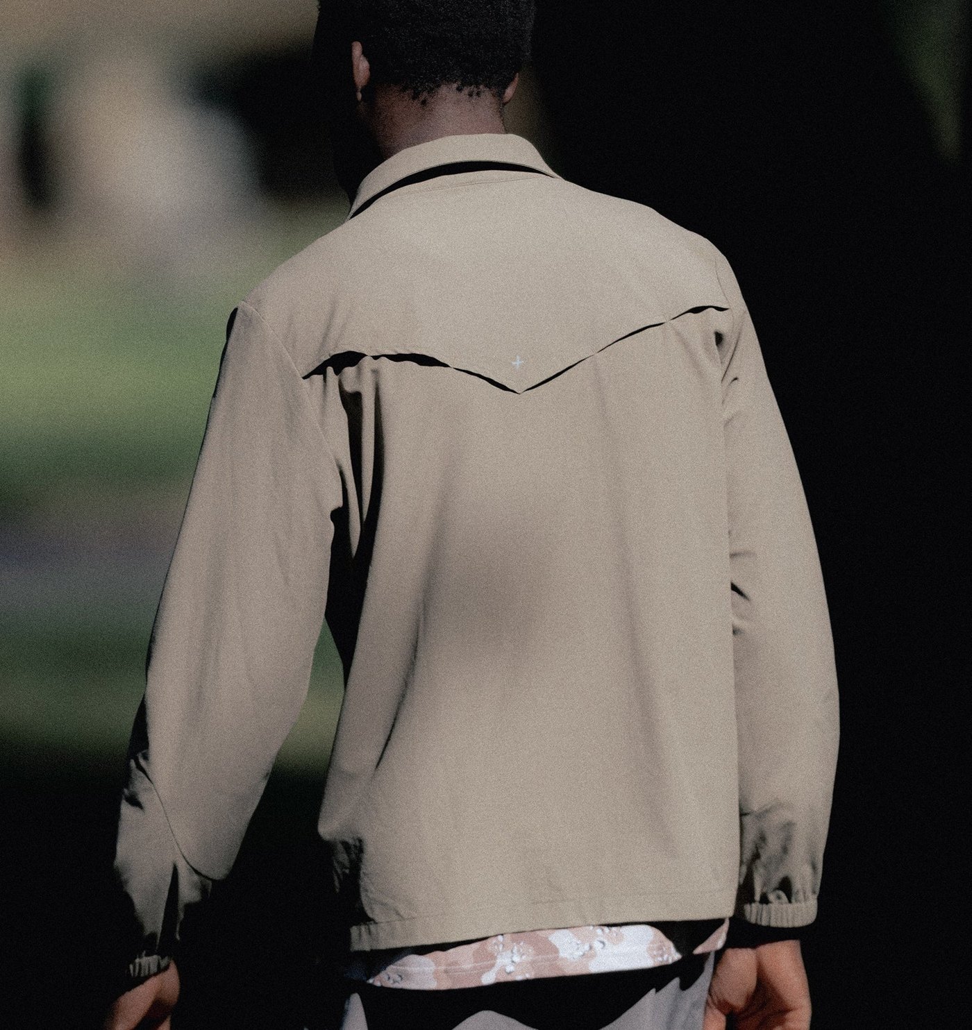 Back of the stone trail shirt showing the vented V yoke, worn outdoors