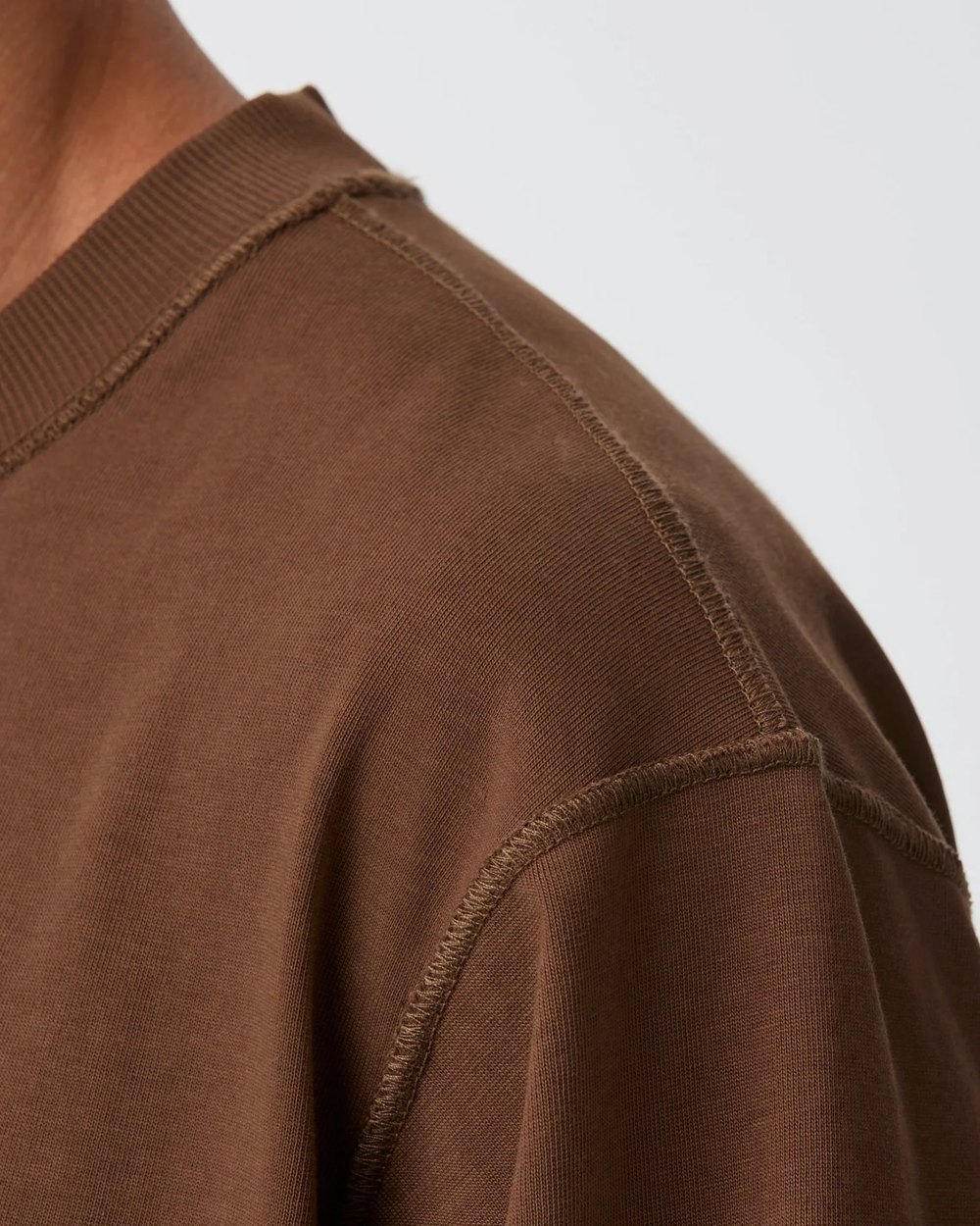 Close up of the crop box tee shoulder and raw edge seams