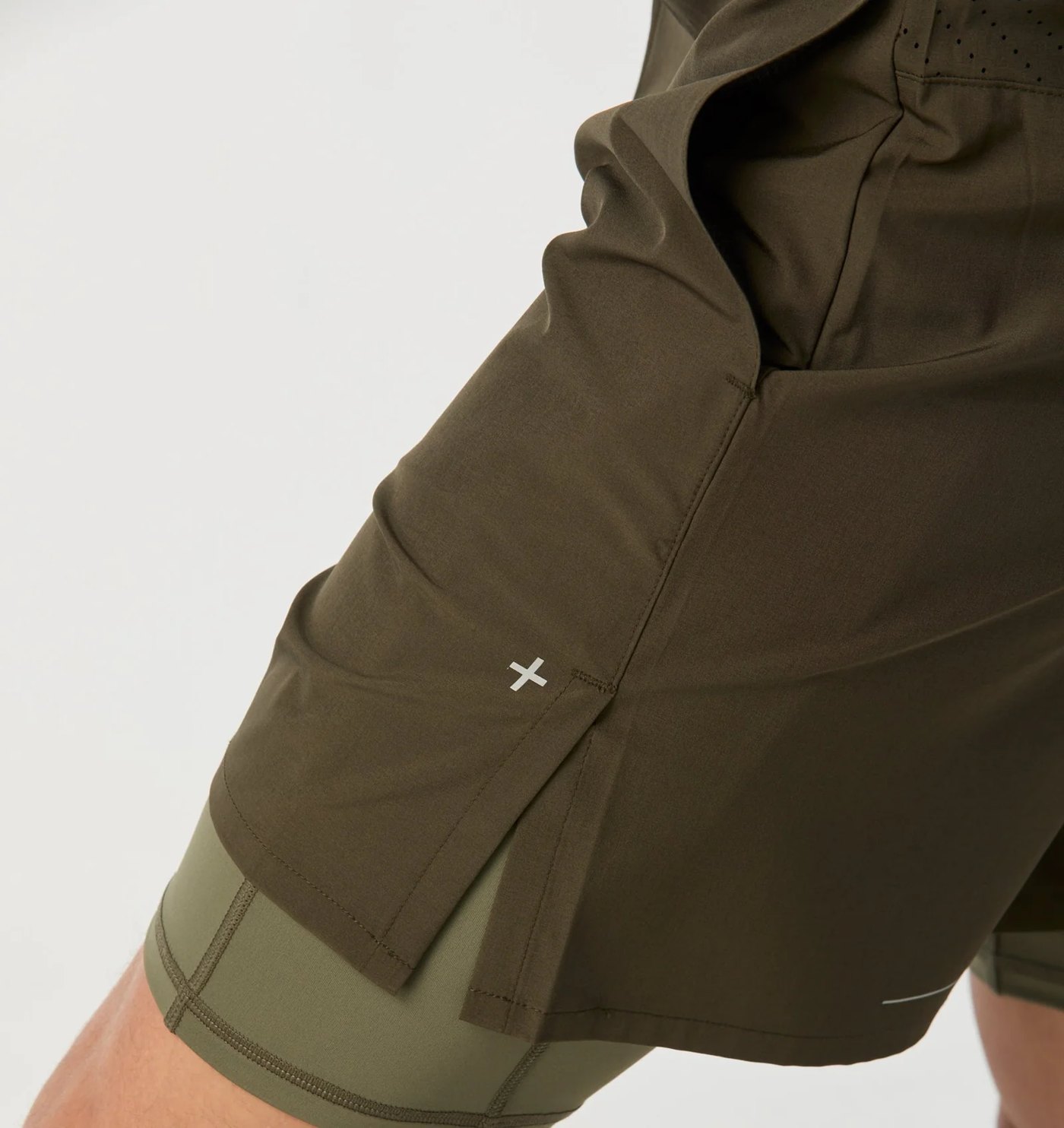 Close-up of the split hem, reflective cross mark and compression liner