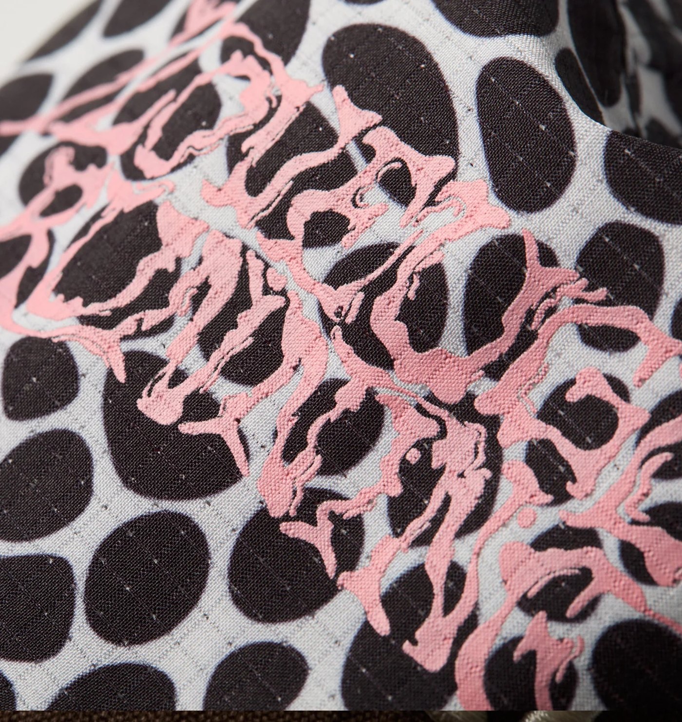 Close-up of the pink liquified lettering on the snakeskin ripstop